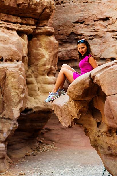 istock girl sitting on a rock 452546963