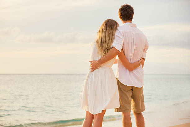 istock Happy romantic couple on the beach at sunset 452547993