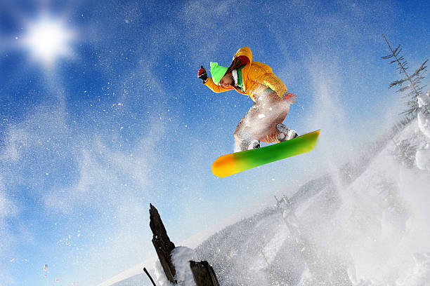 istock Snowboarder jumping against blue sky 452548147