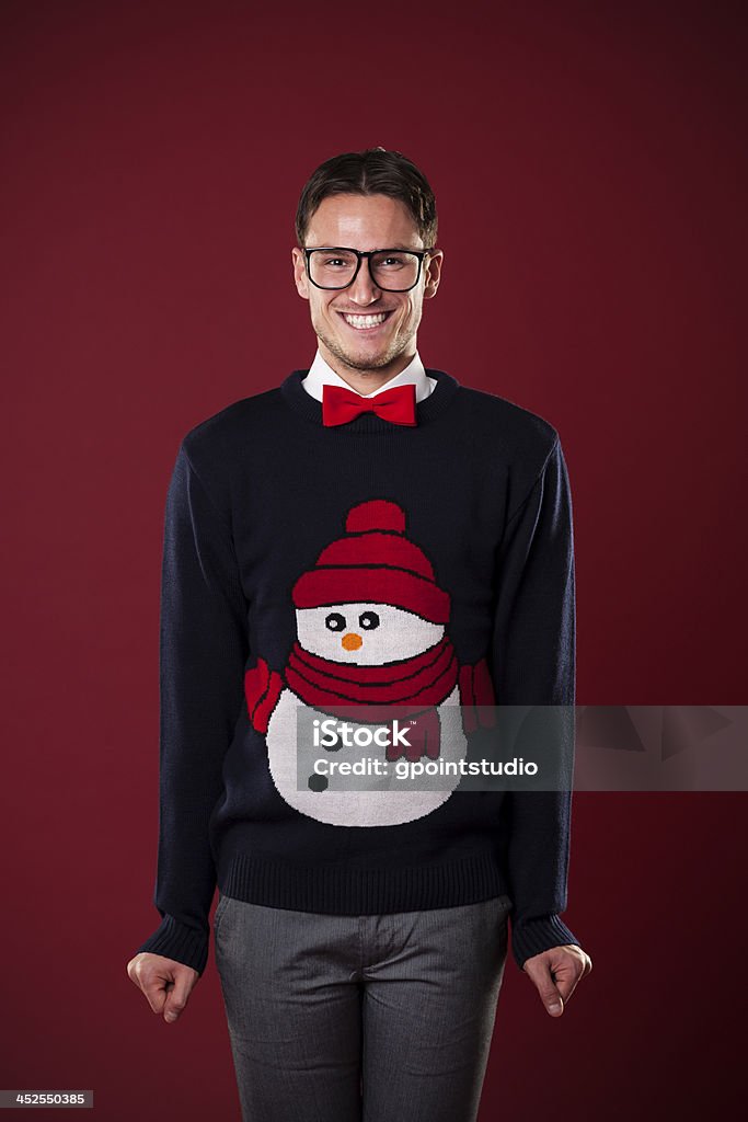 Portrait of funny man wearing sweater with snowman Portrait of funny man wearing sweater with snowman  Ugly Sweater Stock Photo