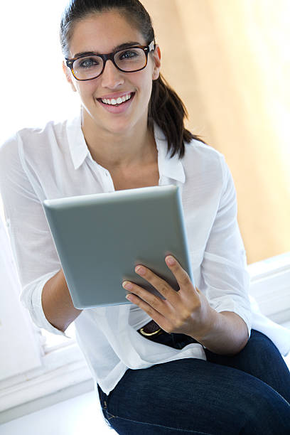 istock Beautiful young woman with digital tablet 452559873