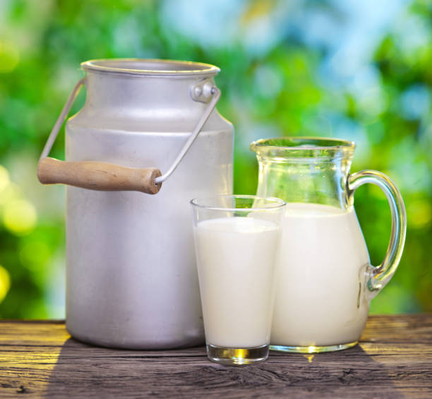 istock Milk in various dishes on the old wooden table. 452565203