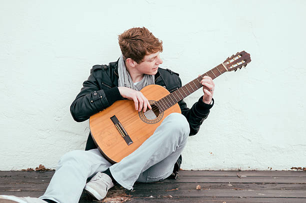 Playing acoustic guitar stock photo