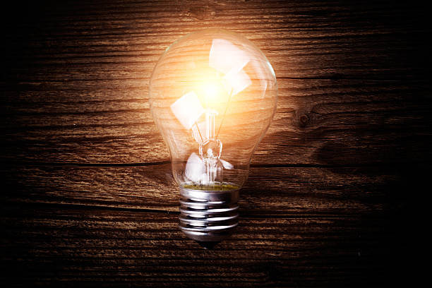 istock glowing bulb on the brown wooden background 452568571