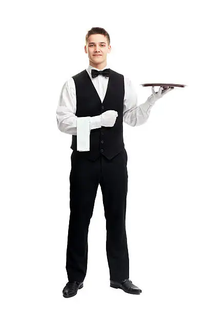 full length portrait of young happy smiling waiter with empty tray isolated on white background