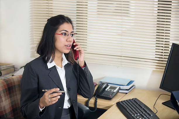 Happy and cheerful Indian Businesswoman talking on phone .