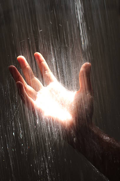 istock Human hand with splash of water 452576885