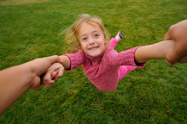 istock Little girl swinging in motion 452577653
