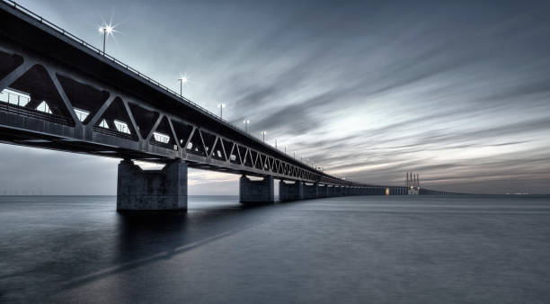 Oresundsbron Link Bridge filtered The Oresund Link Bridge from Sweden looking towards Denmark against spectacular dusk sky. HDR and filtered image for special Science Fiction effect. oresund bridge stock pictures, royalty-free photos & images