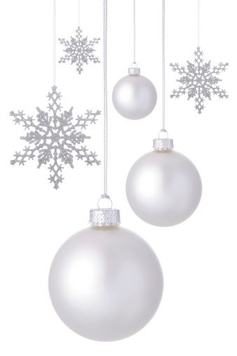 New 2012 white Christmas ornaments and silver glitter snowflakes hanging on a white background.