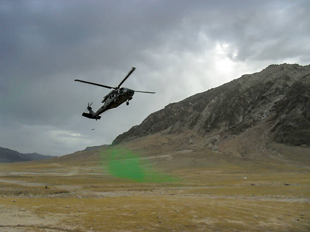 Blackhawk landing on signal smoke In Afghanistan mountain range afghanistan army stock pictures, royalty-free photos & images