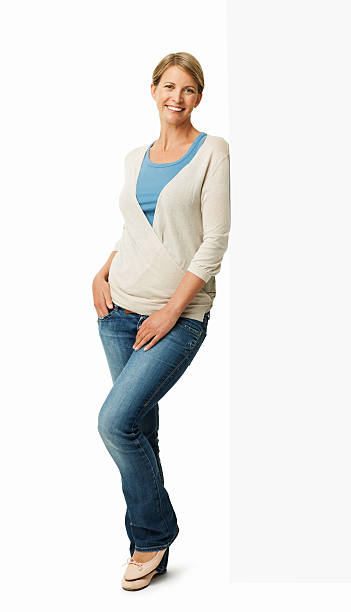 istock Woman In Casuals Leaning On Blank Billboard 452586587