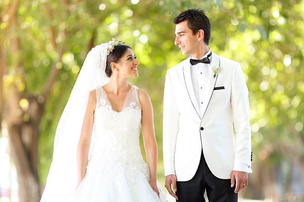 istock Beautiful wedding couple looking 452586869