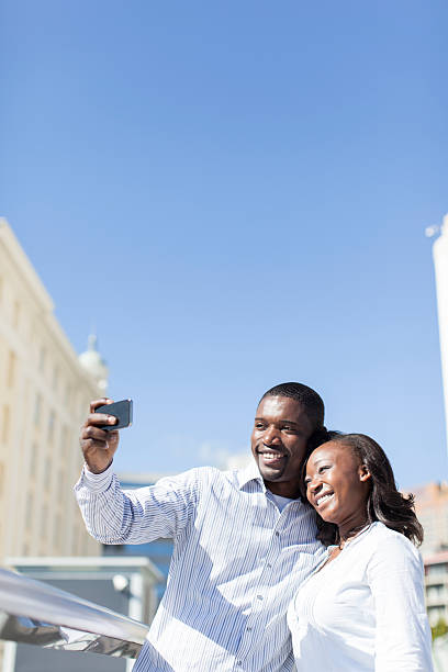 istock Young african male taking a picture with his girlfriend. 452587111