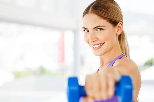 istock Woman Exercising With Dumbbell In Gym 452590065