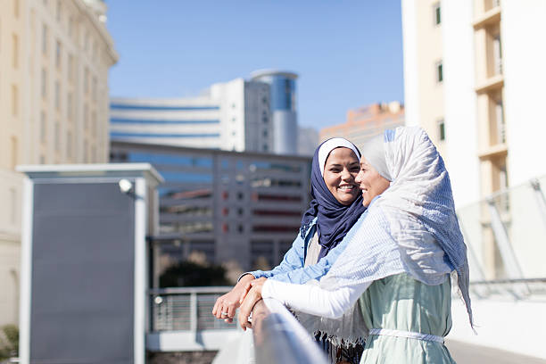 istock Two muslims women having a conversation on the bridge. 452590327