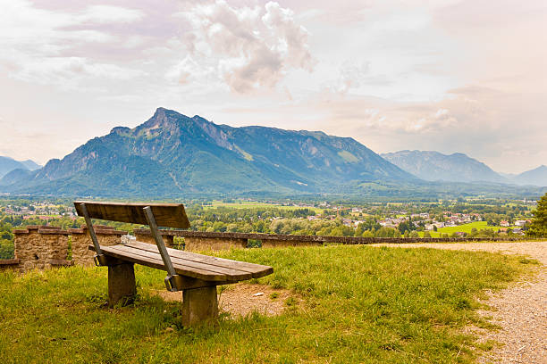 Vacant bench on a hill in Salzburg with a view of Untersberg