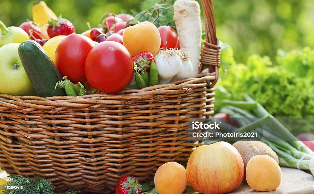 Organic fruits and vegetables in a wicker basket Agriculture Stock Photo