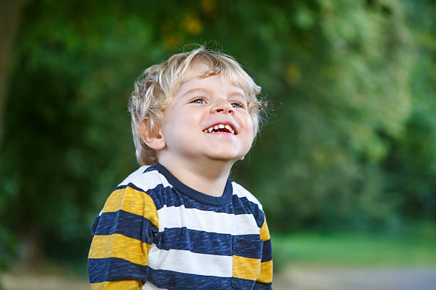istock Little blond boy of two years in autumn forest. 452595355