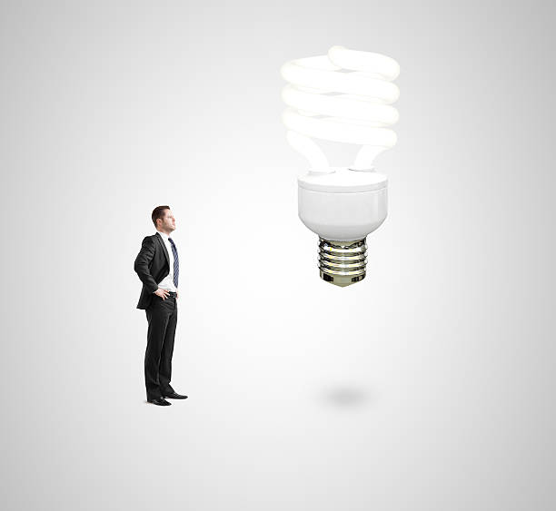 istock man looking on energy lamp 452600015