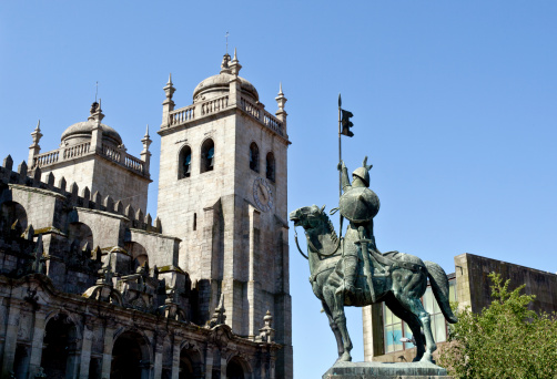 Lateral view of the bell towers of the Porto Cathedral and Statue of Vimara Peres, first Count of Portucale in the 9th century
