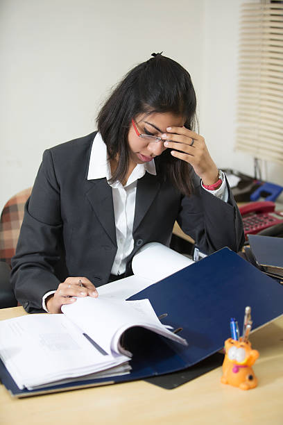 istock Overworked and stressed out Indian business woman working 452602113