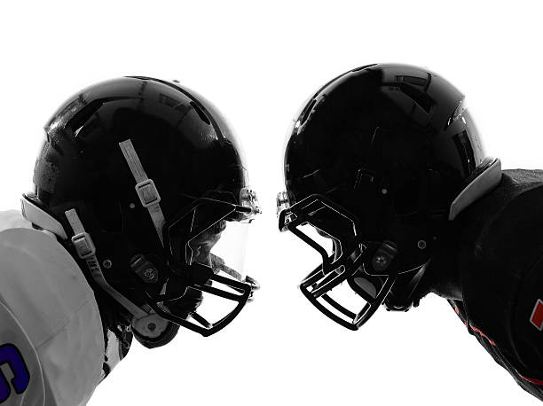 two american football players facing eachother silhouette two american football players face to face in silhouette shadow on white background american football sport stock pictures, royalty-free photos & images