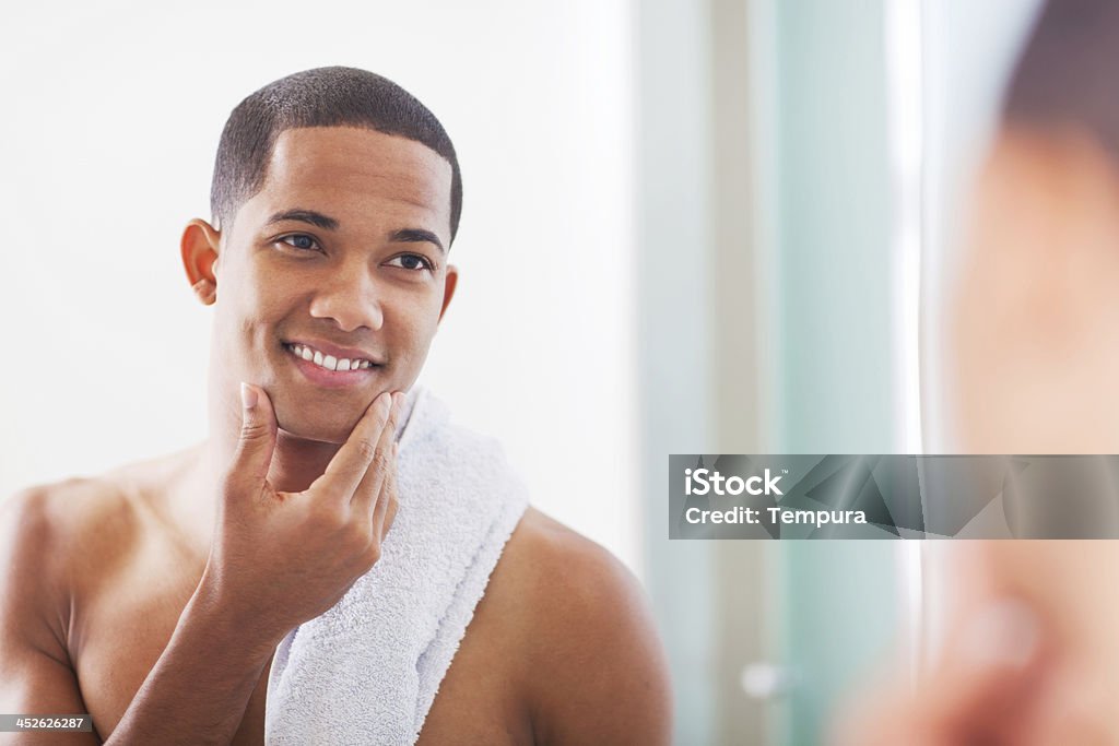 Skin care and shaving. Young man African American man shaving. More files of this model and series on port. Men Stock Photo