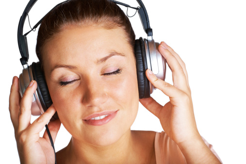 A pretty young girl listening to music with her eyes closed - Daydreaming - Isolated