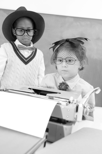 Children playing 'dress up'. Retro-revival office with secretary and typewriter.  Boss stands behind her desk.  