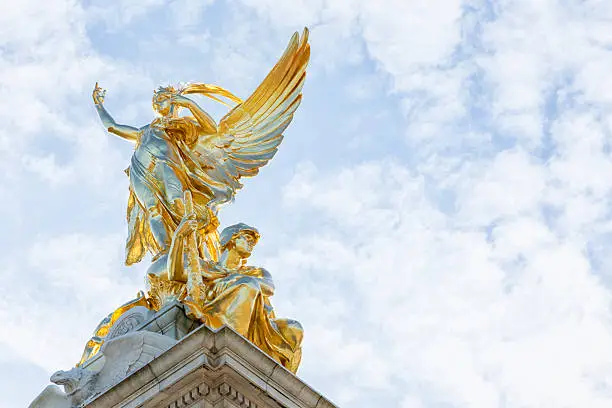 Golden statue of Nike, goddess of Victory on top of Victoria Memorial, Buckingham Palace, London, England