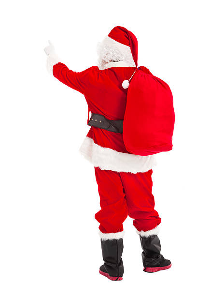 merry Christmas Santa Claus pointing and rear view stock photo