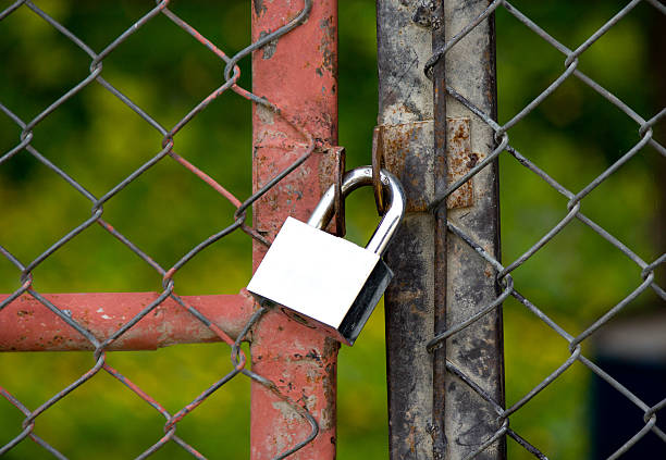 istock Padlock on an iron bars fence 452631351