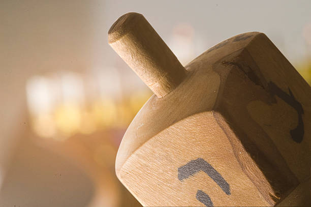 olive wood dreidle with menorah stock photo