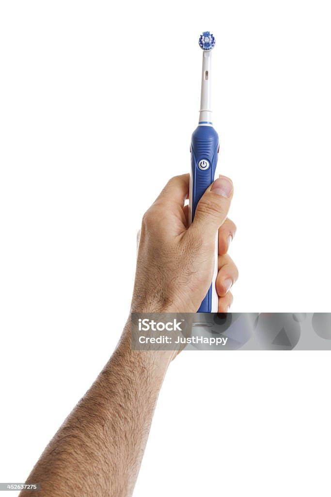 Homem segurando a escova de dentes elétrica na mão. - Foto de stock de Escova de Dentes Elétrica royalty-free