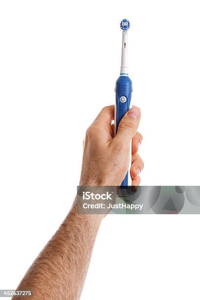 Foto de Homem Segurando A Escova De Dentes Elétrica Na Mão e mais fotos de stock de Escova de Dentes Elétrica