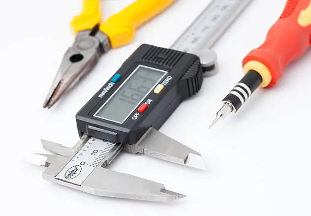 Electronic calliper, Pliers and Screwdriver on white background