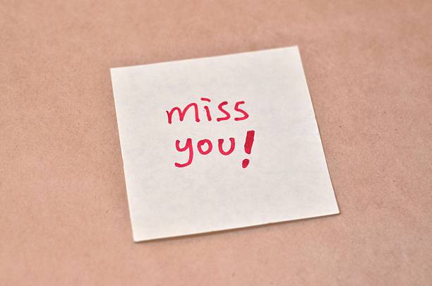 istock Text miss you on the short note texture background 452638551