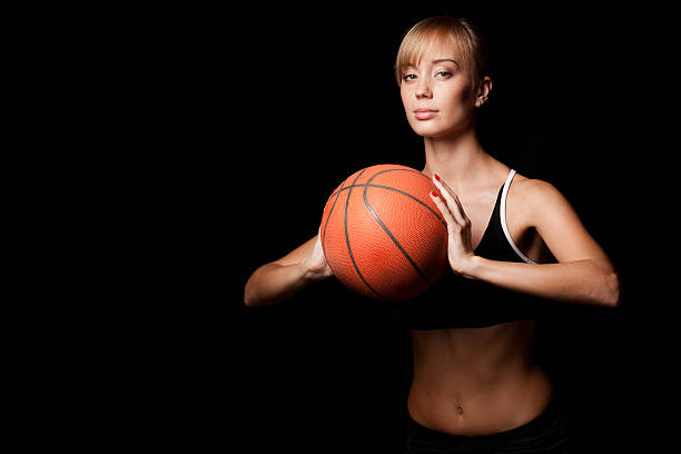 istock woman standing with basketball 452639887