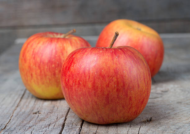 istock Red apple fruit ripe dew on wood background 452650569
