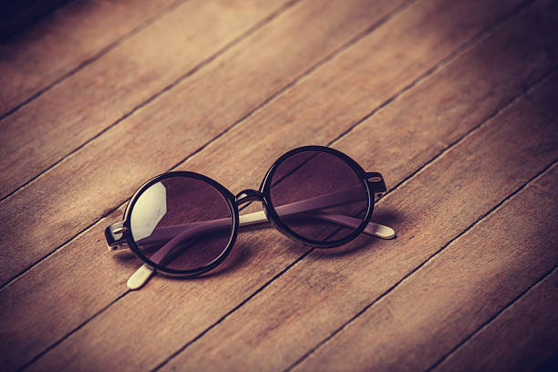 istock Retro sunglasses on wooden table 452651379