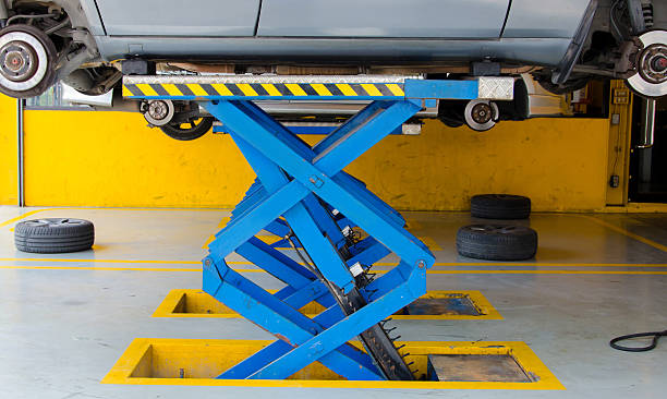 istock Car under repair on hoist at service station 452652859