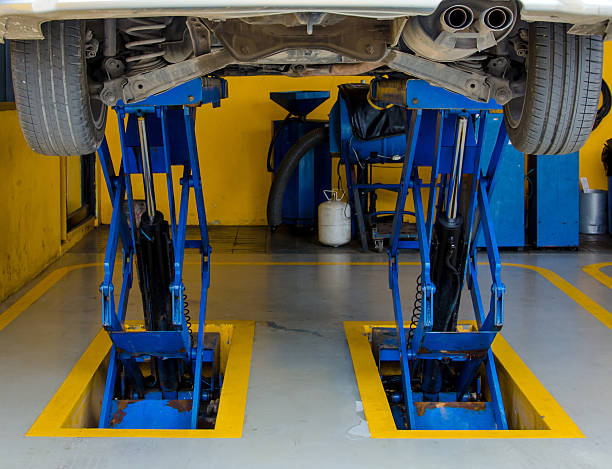 istock Car under repair on hoist at service station 452652897