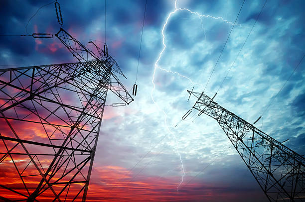 Electricity Towers Dramatic Image of Power Distribution Station with Lightning Striking Electricity Towers lightning tower stock pictures, royalty-free photos & images