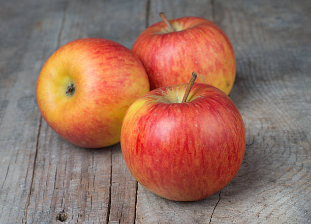 istock Red apple fruit ripe dew on wood background 452663071