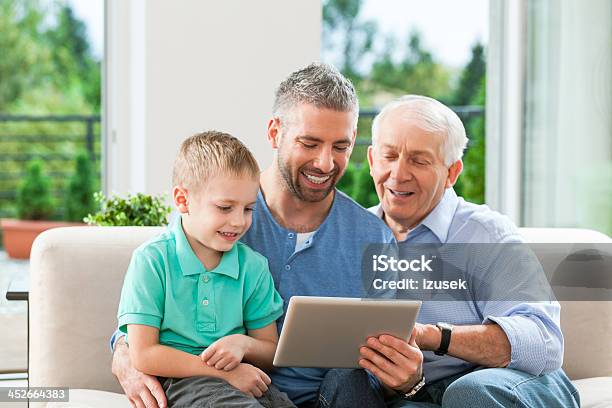 Three Generation Family With Digital Tablet Stock Photo - Download Image Now - 30-34 Years, 30-39 Years, Active Seniors