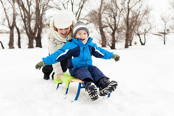 istock Mother with little boy going down in sled 452667587