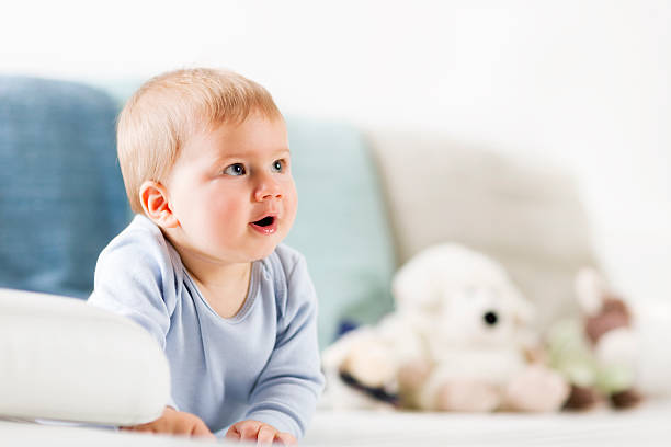istock Lovely baby boy lying on belly and looking up. 452676891