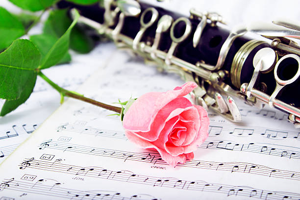 Clarinet On Sheet Music Stock Photo - Download Image Now - Clarinet,  Chamber Music, Rose - Flower - iStock