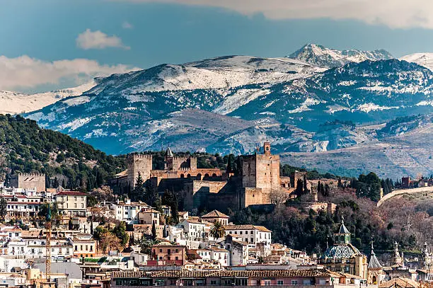 Winter view of famous Alhambra in front of Sierra Nevada, Spain.
